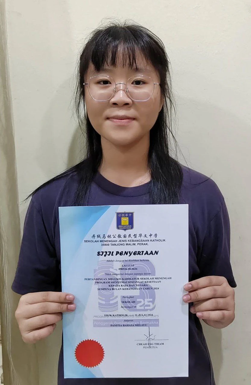 Student holding an art competition certificate