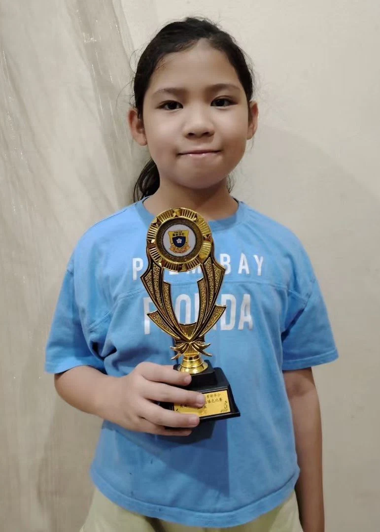 Student holding an achievement trophy