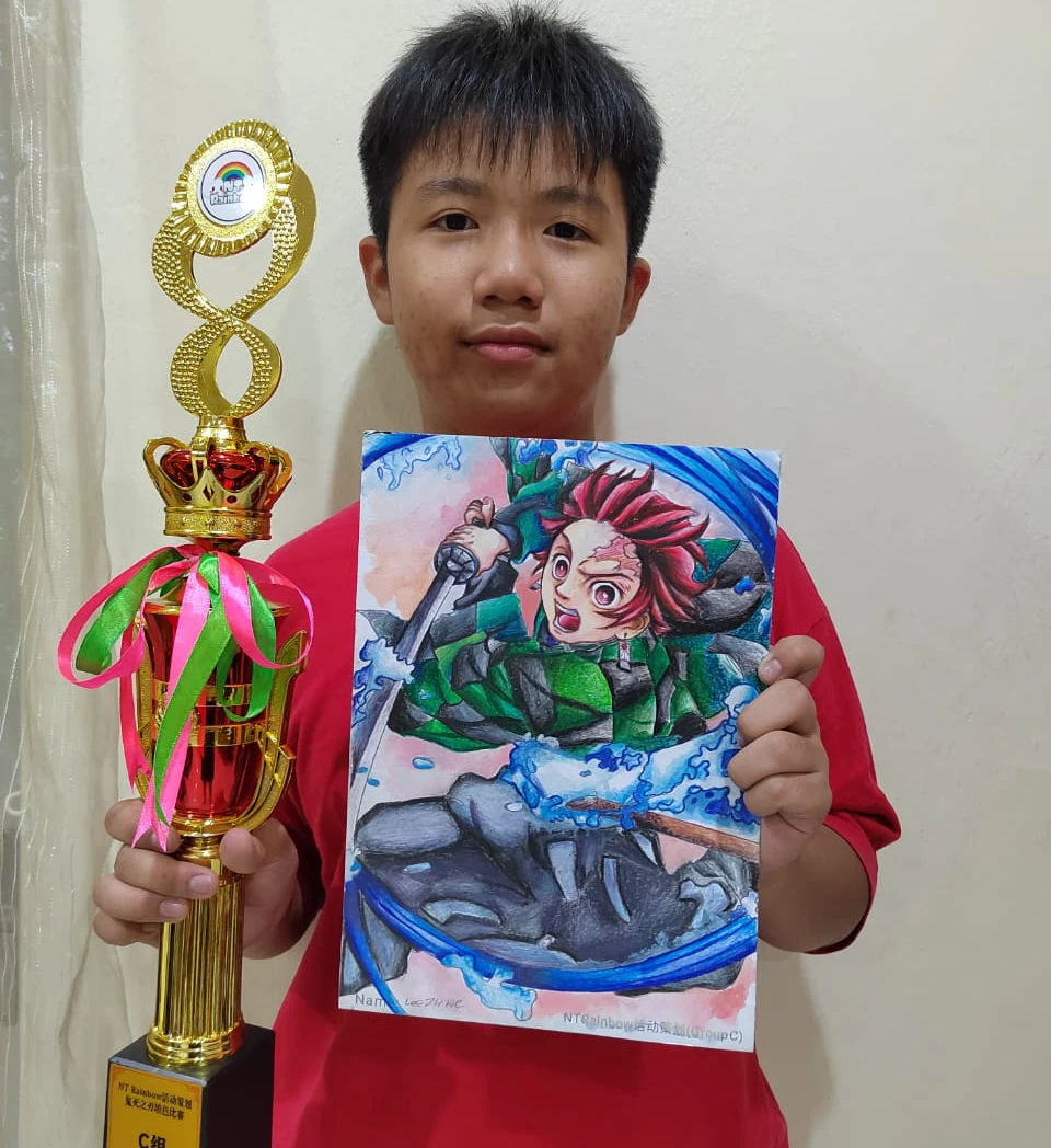 Student holding a trophy and colourful character artwork