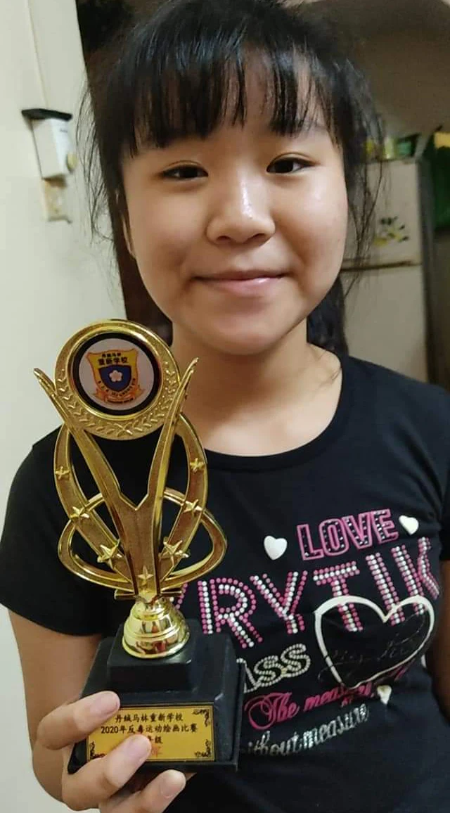 Student holding a music-themed achievement trophy