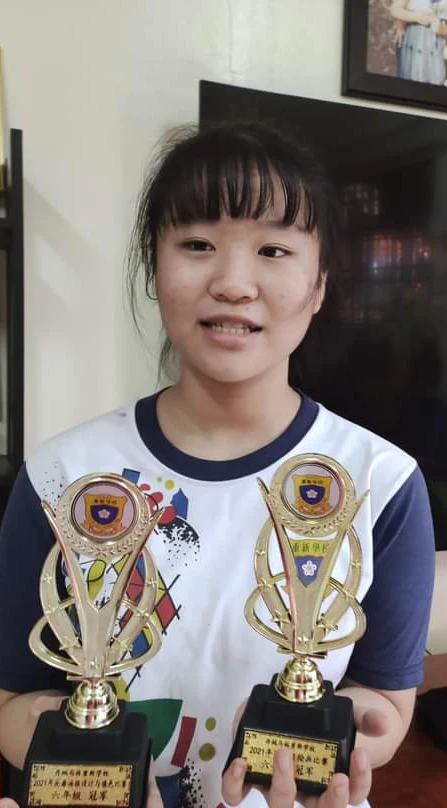 Young student holding an achievement trophy