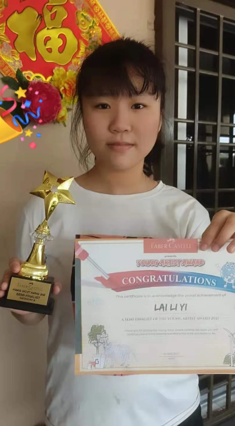 Student holding an achievement trophy and certificate