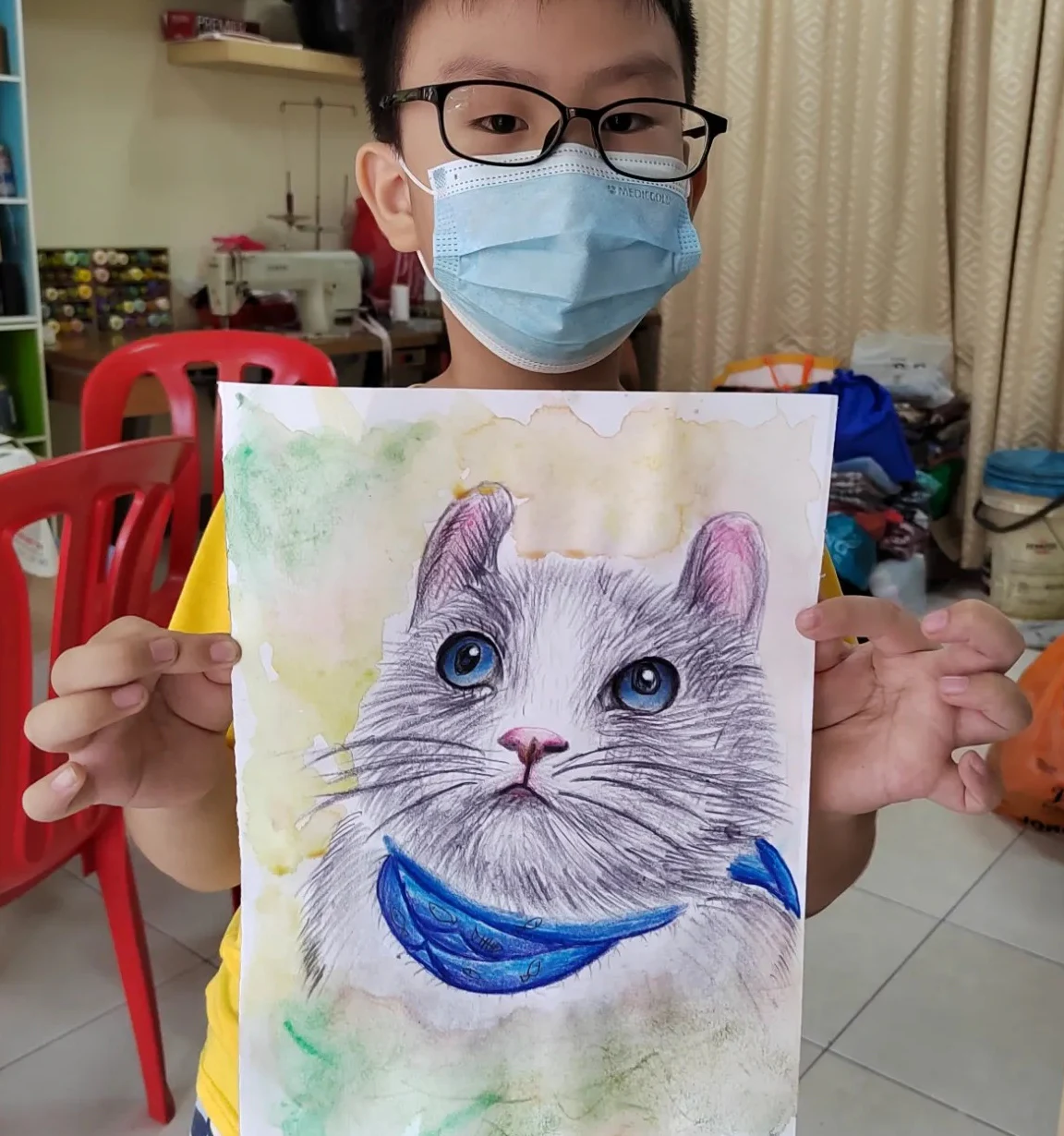 Student holding a detailed cat portrait