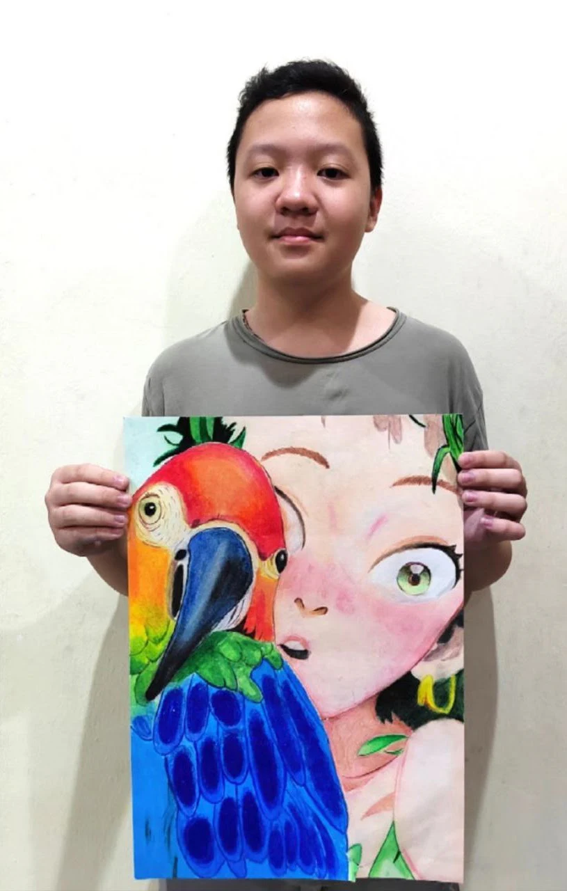 Student holding a colourful macaw and portrait composition