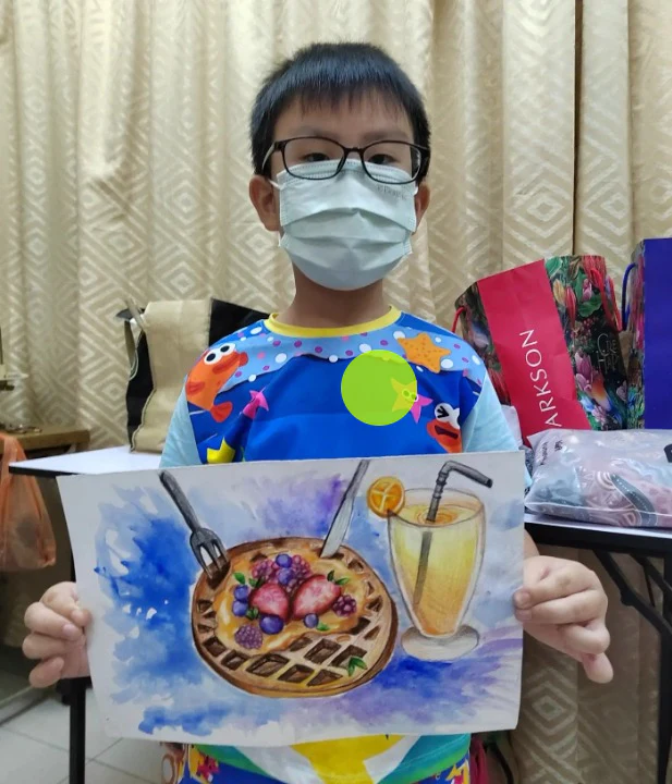 Student holding a colourful waffle and lemonade still life