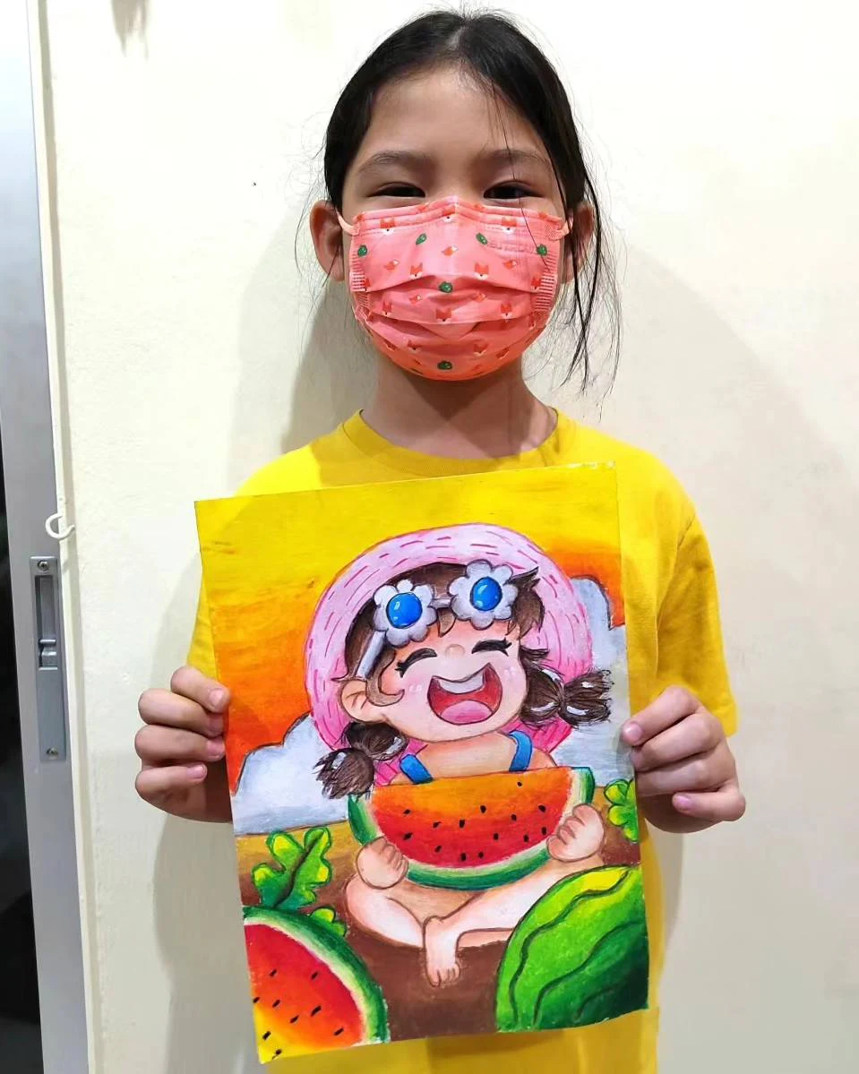 Student holding a bright cartoon character drawing